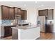 Modern kitchen featuring granite countertops, stainless steel appliances, and a central island at 2303 Angus St, Mead, CO 80542