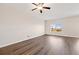 Sunlit living room boasting hardwood floors, a large window, and a versatile, open layout at 2303 Angus St, Mead, CO 80542