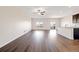 Open-concept living space boasting hardwood floors, ample natural light, and seamless flow to the kitchen at 2303 Angus St, Mead, CO 80542