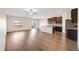 Expansive living space with hardwood floors, access to outdoor patio, and modern kitchen with island at 2303 Angus St, Mead, CO 80542
