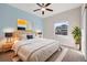 A cozy main bedroom featuring a ceiling fan, a window, and stylish décor at 2303 Angus St, Mead, CO 80542