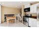 Bright kitchen features stainless steel appliances and an adjacent dining area at 8152 S Everett St, Littleton, CO 80128