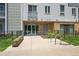 Apartment building entrance with landscaped sidewalk seating and bicycle parking at 2525 Arapahoe St # Rd315, Denver, CO 80205