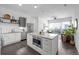 Stylish kitchen open to the living area, featuring white cabinets, stainless steel appliances, and a large island at 2525 Arapahoe St # Rd315, Denver, CO 80205