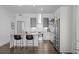 Modern kitchen featuring a breakfast bar, stainless steel appliances, and sleek white cabinets at 2525 Arapahoe St # Rd315, Denver, CO 80205