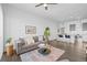 Open-concept living room with a comfortable sofa, hardwood floors, and a view into the modern kitchen at 2525 Arapahoe St # Rd315, Denver, CO 80205