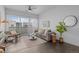 Bright living room with large windows, stylish furnishings, and dark wood floors at 2525 Arapahoe St # Rd315, Denver, CO 80205