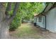 The backyard has green grass, a few trees and a white brick home in the background at 10051 E Walsh Pl, Denver, CO 80247