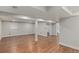 Finished basement with wood-look flooring and neutral-colored walls at 10051 E Walsh Pl, Denver, CO 80247