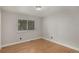 This bedroom features neutral walls, wood floors, and a window for natural light at 10051 E Walsh Pl, Denver, CO 80247