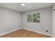 Bright bedroom boasts neutral walls and new wood flooring, providing a clean and modern aesthetic at 10051 E Walsh Pl, Denver, CO 80247