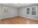 Bright bedroom with hardwood floors and three large windows providing plenty of natural light at 10051 E Walsh Pl, Denver, CO 80247