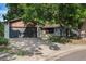 Charming single-story home with a brick facade, mature trees, and a two-car garage at 10051 E Walsh Pl, Denver, CO 80247