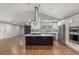 Sleek, modern kitchen with a large center island, stainless steel appliances, and an open floor plan at 10051 E Walsh Pl, Denver, CO 80247