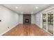 Cozy living room with a modern fireplace, hardwood floors, and sliding doors to the outdoors at 10051 E Walsh Pl, Denver, CO 80247