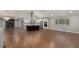Open-concept living room seamlessly connects to a modern kitchen with stainless steel appliances at 10051 E Walsh Pl, Denver, CO 80247