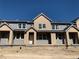 Newly constructed townhome showcasing a modern facade with neutral-toned siding and bright white window trim at 17145 W 91St Ln, Arvada, CO 80007