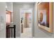 Hallway view looking into bedroom, featuring neutral walls, carpet, and artwork, creating an inviting and stylish transition space at 17145 W 91St Ln, Arvada, CO 80007
