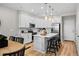 Bright kitchen features white cabinetry, stainless steel appliances, and island with seating at 17145 W 91St Ln, Arvada, CO 80007