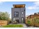 Charming backyard featuring a new privacy fence and patio seating area with a new home at 2395 N Emerson St, Denver, CO 80205