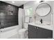 Modern bathroom with black tile, sleek fixtures, and vanity sink at 2395 N Emerson St, Denver, CO 80205