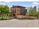 Modern home with brick and metal siding, featuring a well-manicured lawn and professional landscaping at 2395 N Emerson St, Denver, CO 80205