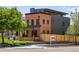 Charming two-story home featuring a brick facade, black accents, and a well-manicured lawn, exuding modern elegance at 2395 N Emerson St, Denver, CO 80205