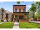 Brick home with a green door, black framed windows, and green lawn in the front yard at 2395 N Emerson St, Denver, CO 80205
