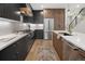 Stylish kitchen with stainless steel appliances, quartz countertops, and hardwood floors at 2395 N Emerson St, Denver, CO 80205