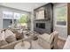 Bright living room with modern furniture, a fireplace, and access to the backyard at 2395 N Emerson St, Denver, CO 80205