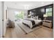 Calm, bright main bedroom with a modern accent wall, balcony, and neutral furnishings at 2395 N Emerson St, Denver, CO 80205