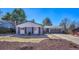 Charming single-story home with a gray painted brick facade, well-manicured front yard and a two-car garage at 3802 E Costilla Ave, Centennial, CO 80122