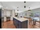 Kitchen island offering counter seating and extra storage, complemented by stainless steel appliances and a nearby dining area at 3802 E Costilla Ave, Centennial, CO 80122