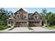 Charming two-story townhome featuring symmetrical design, attached two-car garages, and covered front porches at 6750 Juniper Dr, Thornton, CO 80602