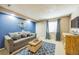 Finished basement with blue accent wall, comfortable seating, and stylish decor at 529 Olympia Ave, Longmont, CO 80504