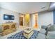 Finished basement area with entertainment center and convenient access to stairs and bathroom at 529 Olympia Ave, Longmont, CO 80504