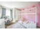 Charming bedroom with decorative pink walls and a unique, cozy house-frame bed at 529 Olympia Ave, Longmont, CO 80504