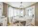 Cozy breakfast nook with round table and farmhouse chandelier at 529 Olympia Ave, Longmont, CO 80504