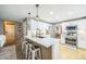 Modern kitchen featuring white cabinets, stainless steel appliances, and a center island with seating at 529 Olympia Ave, Longmont, CO 80504