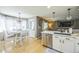 Bright kitchen open to the dining area, featuring modern cabinetry and hardwood floors at 529 Olympia Ave, Longmont, CO 80504