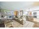 Spacious living room open to the kitchen with a large sectional couch at 529 Olympia Ave, Longmont, CO 80504