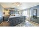 Spacious main bedroom featuring a rustic king-size bed, modern ceiling fan, and beautiful grey and white color scheme at 529 Olympia Ave, Longmont, CO 80504