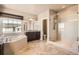 Bright bathroom boasts a luxurious tub, dark cabinets, and glass shower at 11602 Pine Canyon Dr, Parker, CO 80138