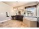 Luxurious bathroom showcasing a soaking tub, vanity area, and elegant fixtures with a tile floor at 11602 Pine Canyon Dr, Parker, CO 80138