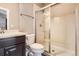 Small bathroom features tiled shower, dark cabinet, and modern fixtures at 11602 Pine Canyon Dr, Parker, CO 80138