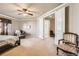 Spacious bedroom with ample natural light, comfortable seating, and neutral color palette at 11602 Pine Canyon Dr, Parker, CO 80138
