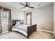 Neutral bedroom featuring a comfortable bed, plush carpeting, and ceiling fan with elegant window coverings at 11602 Pine Canyon Dr, Parker, CO 80138