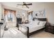 Bedroom features large windows, ceiling fan, and personal decor at 11602 Pine Canyon Dr, Parker, CO 80138