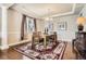 Elegant dining room featuring hardwood floors, coffered ceiling, and ample natural light at 11602 Pine Canyon Dr, Parker, CO 80138