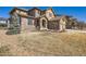 Beautiful stone accented home with manicured front yard and mature landscaping at 11602 Pine Canyon Dr, Parker, CO 80138